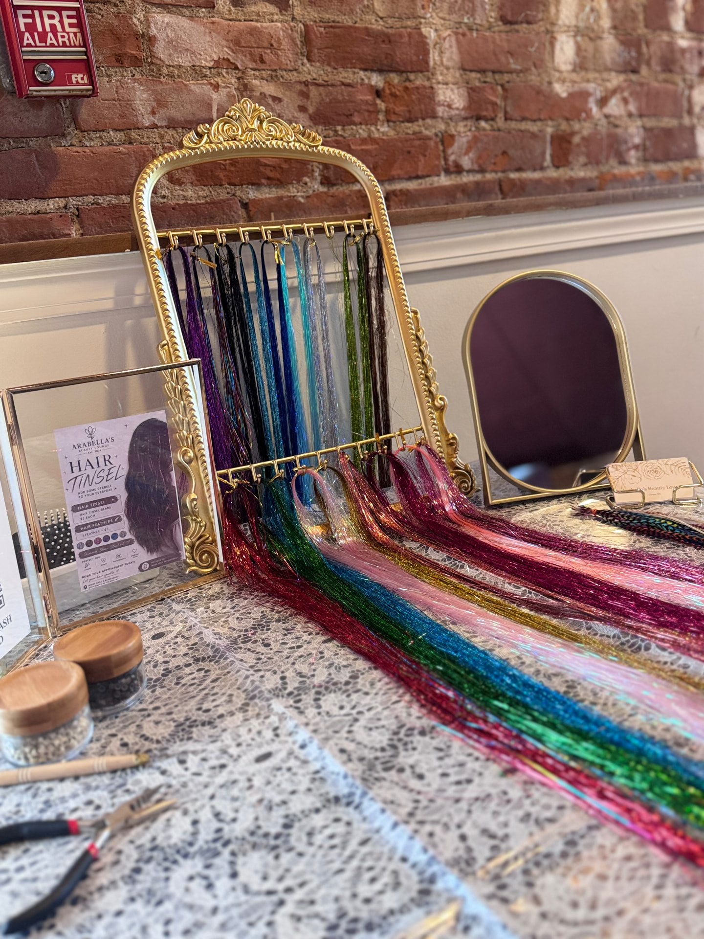 Hair tinsel color display with gold mirror at Arabella's Beauty Lounge